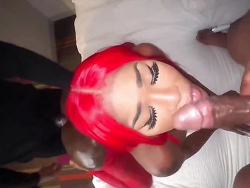 Oiledup redhead shemale takes two cocks